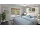 This light and airy bedroom has a large window and sliding glass door leading to the balcony at 80 Sycamore Ct, Palm Harbor, FL 34683