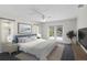 A serene bedroom with neutral tones, complemented by soft blue accents and access to a private patio at 80 Sycamore Ct, Palm Harbor, FL 34683
