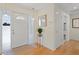 Inviting entryway featuring hardwood floors, a decorative front door, and modern lighting at 80 Sycamore Ct, Palm Harbor, FL 34683