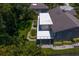 Aerial view of a home featuring a flat roof and lush, tropical landscaping at 80 Sycamore Ct, Palm Harbor, FL 34683