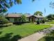 Well-maintained single-story home with a neatly manicured lawn and mature landscaping at 80 Sycamore Ct, Palm Harbor, FL 34683