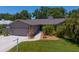 Well-maintained home exterior with a two-car garage, manicured lawn, and mature landscaping at 80 Sycamore Ct, Palm Harbor, FL 34683