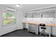 Bright garage space with a large window, utility sink, and storage solutions at 80 Sycamore Ct, Palm Harbor, FL 34683