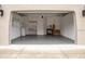 Spacious garage featuring built-in storage, ample lighting, and an epoxy floor at 80 Sycamore Ct, Palm Harbor, FL 34683