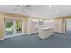 Bright kitchen featuring an island with a sink, bar stool seating and lots of cabinet space at 80 Sycamore Ct, Palm Harbor, FL 34683