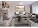 Elegant living room featuring a stone fireplace, classic furniture, and a charming blend of textures and tones at 80 Sycamore Ct, Palm Harbor, FL 34683