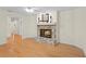 Bright living room featuring a stone fireplace, hardwood floors, and neutral walls at 80 Sycamore Ct, Palm Harbor, FL 34683