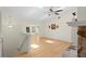 Spacious living area featuring hardwood floors, skylight and stone fireplace at 80 Sycamore Ct, Palm Harbor, FL 34683