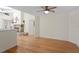 Open floorplan with hardwood floors, stone fireplace, and high ceilings with fan at 80 Sycamore Ct, Palm Harbor, FL 34683