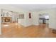Bright open living area featuring hardwood floors, stone fireplace, and a view into the kitchen at 80 Sycamore Ct, Palm Harbor, FL 34683