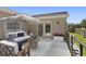 A charming outdoor space features a comfortable sofa, chairs, and a side table shaded by an umbrella at 80 Sycamore Ct, Palm Harbor, FL 34683