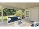 Inviting covered patio with a view of the landscaped backyard and green lawn at 80 Sycamore Ct, Palm Harbor, FL 34683