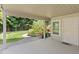 Welcoming covered patio space with a view of the lush, green backyard at 80 Sycamore Ct, Palm Harbor, FL 34683