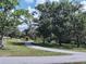 Curving walking path through a park-like setting, perfect for leisurely strolls and exercise at 80 Sycamore Ct, Palm Harbor, FL 34683
