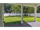 View of the backyard featuring a well-manicured lawn, trees, and a privacy fence at 807 W Kentucky Ave, Tampa, FL 33603