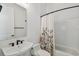 Bright bathroom featuring a floral shower curtain, white subway tile, and a modern sink with matte black fixtures at 807 W Kentucky Ave, Tampa, FL 33603