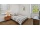 Bedroom with hardwood floors, natural light, a queen-size bed, and a nightstand at 807 W Kentucky Ave, Tampa, FL 33603