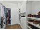 Walk-in closet with built-in shelving, hanging rods, and drawers for organized storage at 807 W Kentucky Ave, Tampa, FL 33603