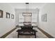 Elegant dining room with a large wooden table, bench seating, and a modern chandelier at 807 W Kentucky Ave, Tampa, FL 33603