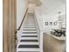 Inviting entryway featuring a staircase with dark wood treads and a view into the dining area at 807 W Kentucky Ave, Tampa, FL 33603