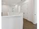 Bright upstairs hallway featuring hardwood floors, white walls, and view to the staircase at 807 W Kentucky Ave, Tampa, FL 33603