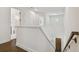Bright hallway featuring hardwood floors, white walls, and a staircase leading to the lower level at 807 W Kentucky Ave, Tampa, FL 33603
