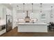 Modern kitchen featuring white cabinetry, stainless steel appliances, and a center island at 807 W Kentucky Ave, Tampa, FL 33603