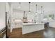 This kitchen features white cabinets, stainless steel appliances, and a large central island at 807 W Kentucky Ave, Tampa, FL 33603