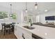 This kitchen island has a sink and a table with chairs nearby, and a view of the living room at 807 W Kentucky Ave, Tampa, FL 33603