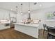 Modern kitchen featuring white cabinetry, stainless steel appliances, and a center island at 807 W Kentucky Ave, Tampa, FL 33603