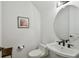 Cozy half bathroom with a modern vanity and a round mirror at 807 W Kentucky Ave, Tampa, FL 33603
