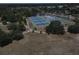 Aerial view of multiple tennis courts, a basketball court, and walking paths in a park-like setting at 8601 N 28Th St, Tampa, FL 33604