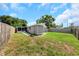 Spacious backyard with a well-maintained lawn, wooden fence, and mature trees at 8805 Plum Grove Ct, Tampa, FL 33634