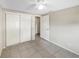 This bedroom offers tile floors, an overhead fan, and a double-door closet at 8805 Plum Grove Ct, Tampa, FL 33634
