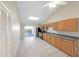 Open kitchen with wood cabinets and black appliances, and a sliding glass door to the lanai at 8805 Plum Grove Ct, Tampa, FL 33634