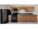 The kitchen has wooden cabinets, black appliances, and countertop at 8805 Plum Grove Ct, Tampa, FL 33634