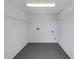 This is a laundry room with white walls and grey floors at 8805 Plum Grove Ct, Tampa, FL 33634
