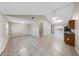 Open living space features tile floors, neutral walls, and sliding glass doors to the lanai at 8805 Plum Grove Ct, Tampa, FL 33634