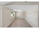 Neutral room with a window allowing natural light and tile flooring at 8805 Plum Grove Ct, Tampa, FL 33634