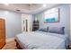 Comfortable bedroom with a large bed, blue walls, and decorative artwork at 945 8Th N St, St Petersburg, FL 33712