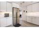 Kitchen with a stainless steel refrigerator, white cabinets, and a neutral color scheme at 945 8Th N St, St Petersburg, FL 33712