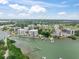 Aerial view of luxury condos and boat docks surrounded by lush greenery and waterfront access at 100 Oakmont Ln # 310, Belleair, FL 33756