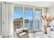 Relaxing chair on a balcony overlooking scenic water view with trees and open sky at 100 Oakmont Ln # 310, Belleair, FL 33756