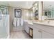 Bathroom vanity featuring dual sinks, white countertops, and built-in vanity at 100 Oakmont Ln # 310, Belleair, FL 33756