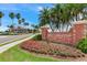 Belleair Country Club entrance featuring manicured landscaping and a brick sign at 100 Oakmont Ln # 310, Belleair, FL 33756