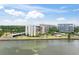 Waterfront condo building with lush landscaping and gorgeous water views, offering a serene and luxurious living environment at 100 Oakmont Ln # 310, Belleair, FL 33756