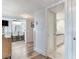 Hallway view of the kitchen, bathroom, and crystal chandelier at 100 Oakmont Ln # 310, Belleair, FL 33756