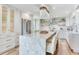 Open kitchen features an island with seating, stainless steel appliances, and plenty of cabinet space at 100 Oakmont Ln # 310, Belleair, FL 33756