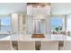 Beautiful kitchen island features seating, modern stainless appliances, a decorative light fixture, and a window seat at 100 Oakmont Ln # 310, Belleair, FL 33756