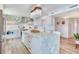 Bright kitchen features an island with seating, granite countertops, and stainless steel appliances at 100 Oakmont Ln # 310, Belleair, FL 33756